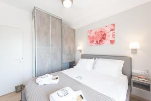 a bedroom with a bed with two towels on it at Iviskos Apartment - Hellenic Apartments Avlona in Oinófita