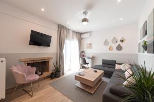 a living room with a couch and a fireplace at Iviskos Apartment - Hellenic Apartments Avlona in Oinófita