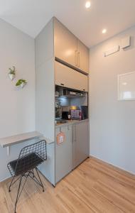 a kitchen with a desk and a chair in a room at Masticha Apartment in Oinófita