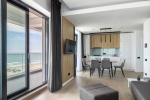 a living room with a view of the ocean at Sea On Mamaia in Mamaia