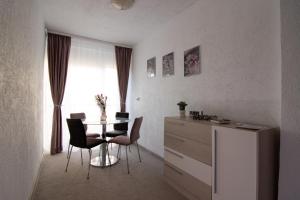 a room with a table and chairs and a window at Happy Residence Sibiu in Sibiu