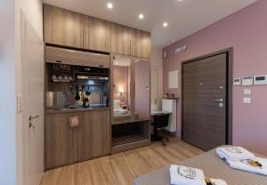 a bedroom with a kitchen with a sink and a desk at Chamomile Apartment - Hellenic Apartments Avlona in Oinófita