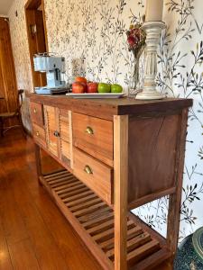 a wooden dresser with apples on top of it at Hotel Boutique Casa&Alma in Puerto Varas