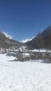 a truck parked in a snow covered field at Villa millefiori falda argentera in Sauze di Cesana