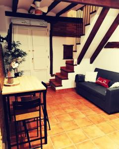 a living room with a couch and a table at Holiday Duplex Casco Antiguo in Logroño