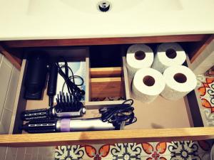 a drawer with rolls of toilet paper and other items at Holiday Duplex Casco Antiguo in Logroño