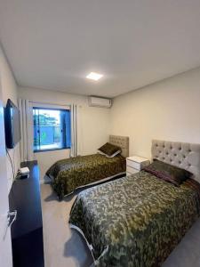 Ένα ή περισσότερα κρεβάτια σε δωμάτιο στο Casa de Praia - Gravatá Navegantes - SC