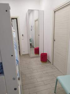 a room with two mirrors and a tiled floor at Eleonora's Home in Naples