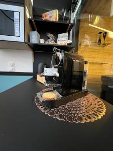 a coffee maker sitting on top of a counter at Les suites de Stanislas jacuzzi & spa in Nancy