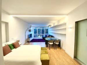 a bedroom with a bed and a desk in a room at Estoril 3 - Beach side Casino Garden Apartment in Estoril +28 photos