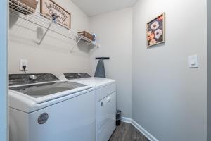 a laundry room with a sink and a washing machine at Spacious 3BR Home on Sprawling Serene Grounds in Kingston