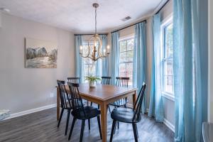 a dining room with a wooden table and chairs at Spacious 3BR Home on Sprawling Serene Grounds in Kingston