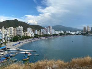 a group of boats in a body of water next to a city at Rancho Ayala II in Santa Marta