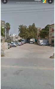 a parking lot with a lot of cars parked at Motzkin sweet in Qiryat Motzkin