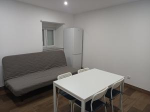 a bedroom with a bed and a table and chairs at Casa Amado Fundão in Fundão