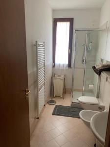 a bathroom with a shower and a toilet and a sink at Dante Zara in Borgata Zarattini