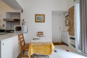 a small kitchen with a table and a microwave at Appartement Claudia - Central - Very close to Sea - Calm - AC in Nice