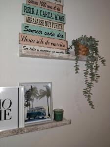 a shelf with a picture and a sign on a wall at La fuente in Güéjar-Sierra