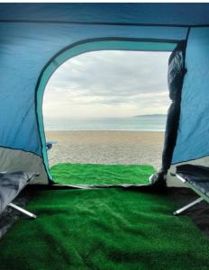 a view of the inside of a tent with the beach at Avistamiento de Ballenas y Campamento Todo incluido!! Mínimo 3 noches en Mag Bay in Punta Cove