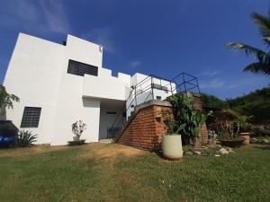 a white building on top of a grass field at Loft con jardín 1 in Puerto Vallarta