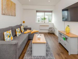 a living room with a couch and a table at Ws Apartments - Luxury 1 bed in Watford Central in Watford