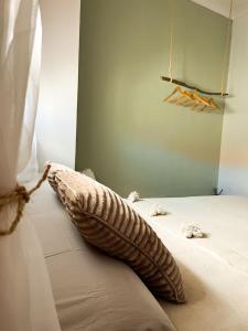 a pillow sitting on a bed in a bedroom at Casa Bienvenida in Bienvenida