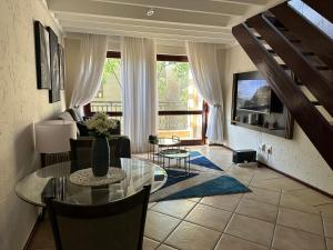 a living room with a table and chairs and a window at Luxurious Loft Condo in Fourways - A Hotel Experience with a Personal Touch in Sandton