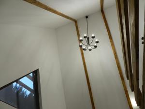 a chandelier hanging from a ceiling in a room at ALI HOUSE in Poiana Fagului +42 photos