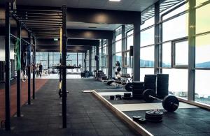 a gym with large windows and a person in the background at Enjoy MTB downhill and XC, hiking and SPA in Åre 29th July to 5th Aug at Holiday Club in Åre