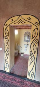 a bathroom with a sink and a toilet in a room at Camp M'hamid Ras N'khal in Mhamid