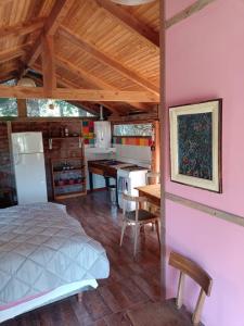 a bedroom and kitchen with a bed and a table at BAJO EL ÑIRE in San Carlos de Bariloche