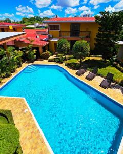 a swimming pool in front of a house at Hotel Los Pinos in Managua