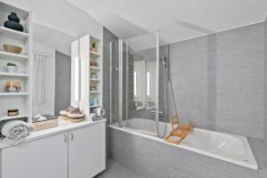 a white bathroom with a tub and a shower at A&Y Chalet zum goldenen Hirsch in Davos