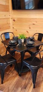 a black table and chairs with bowls and plants on it at Blue Buffalo Resort in Island Park