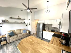 a living room with a couch and a kitchen at F Lakefront! Remodeled, Sleeps 4, Boat Slip, Patio, WiFi, Cable, Pool in Osage Beach