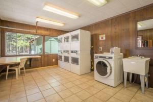 a kitchen with a washing machine and a washer at The Blue Devil Cabin #5 at Blue Spruce RV Park & Cabins in Tuckerville