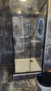 a shower with a glass door in a bathroom at Private room in the centre of Tilburg in Tilburg