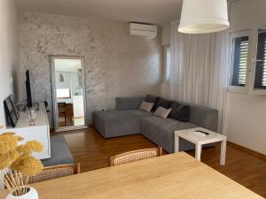 a living room with a couch and a table at Villa LeANN in Okrug Donji