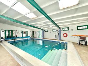 a large indoor swimming pool with a swimming pool at Cave Houses Ed Yara and Nadieh with PRM facilities in Margen de Abajo