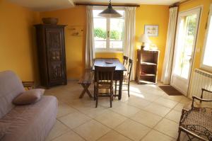 a living room with a table and a couch at Le petit Bacalan in Mormoiron