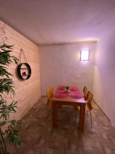 a dining room with a table with purple plates on it at Apartmány u náměstí in Prachatice