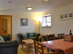 a dining room with a table and chairs and a table and a table and a at Owl Cottage in Flamborough