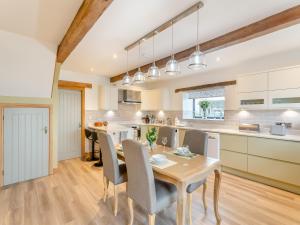 a kitchen and dining room with a table and chairs at Baxter Barn in Carleton