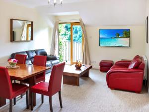 sala de estar con mesa y sillas rojas en Family Lodge No, 4 - Uk45693 en Moulin