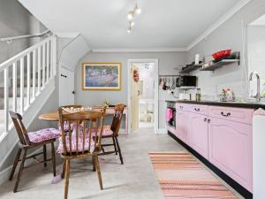 a kitchen with a table and chairs and a sink at The Coach House- Uk45660 in Bishops Castle