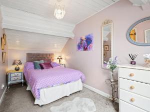 a bedroom with a bed and a dresser and a mirror at The Coach House- Uk45660 in Bishops Castle