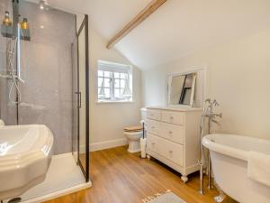 a bathroom with a shower and a sink and a toilet at Abbey Barn Farmhouse in Wereham