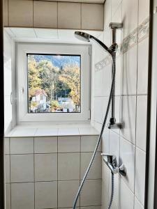 a shower in a bathroom with a window at Central Kitz Apartments in Kitzbühel