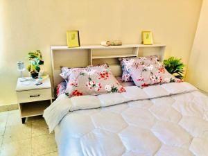a bedroom with a large bed with pink pillows at GREEN HOUSE in Al Ain