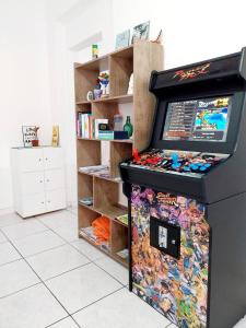 a refrigerator in a room with a book shelf at Hostel Bahia in Porto Alegre